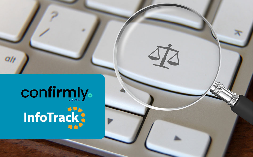 magnifying glass over keyboard with law scales icon