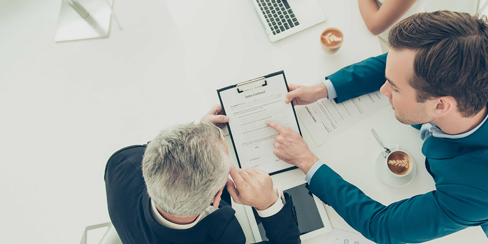 a man pointing out an element of a contract