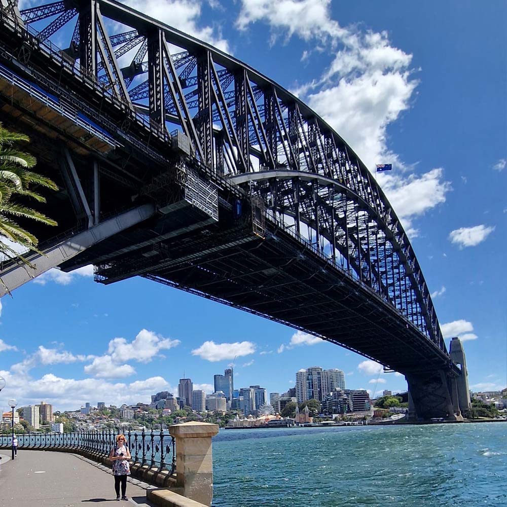 Harbour bridge with woman standing below