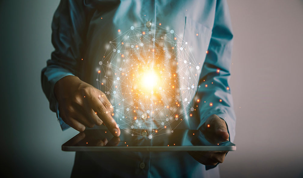 a man using a tablet with a cloud of data above it