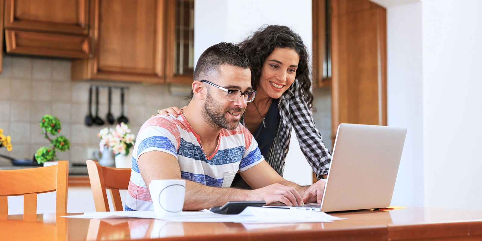 couple looking at laptop together, smiling