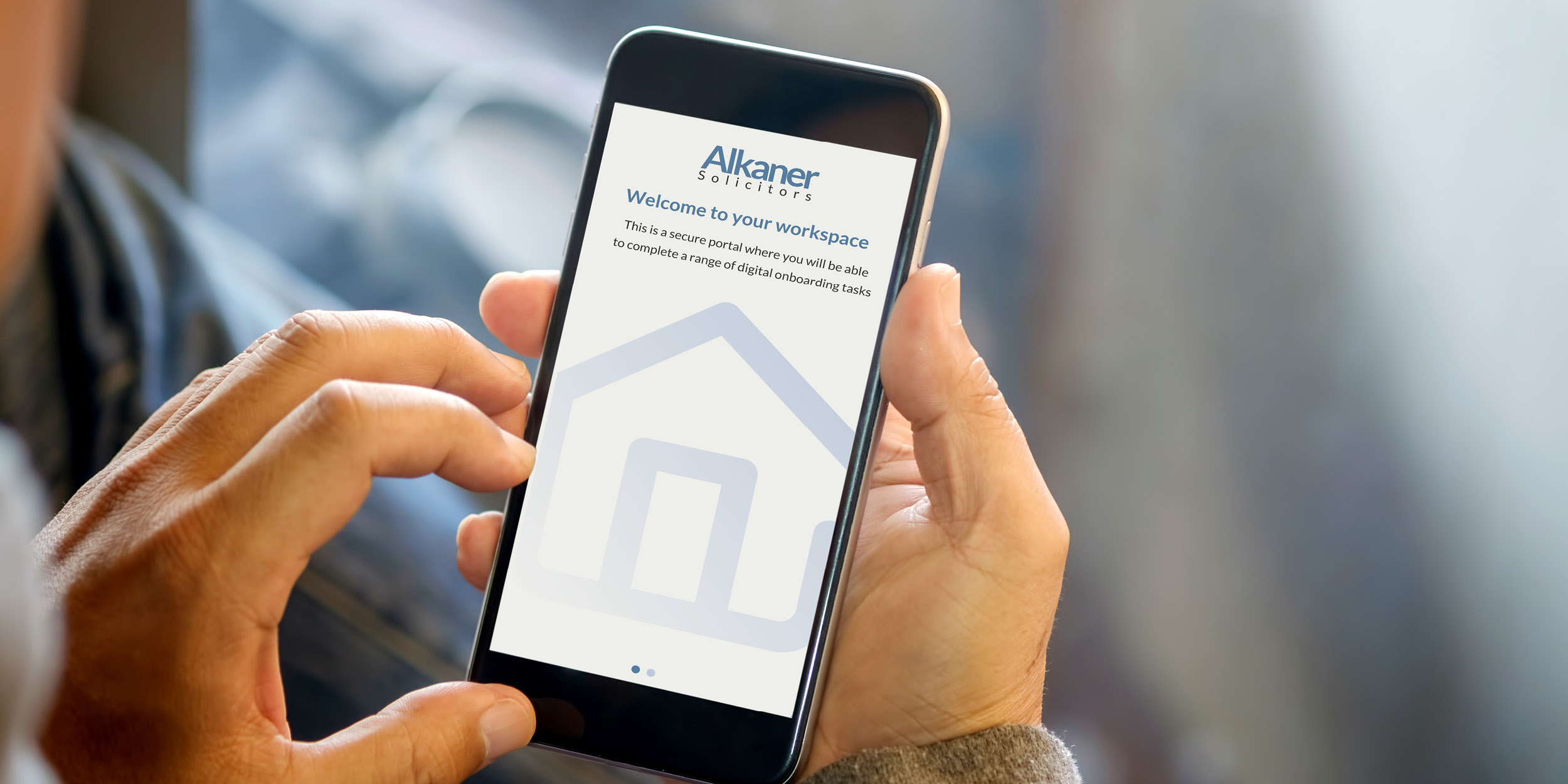 Hands holding mobile phone with Alkaner solicitors welcome screen